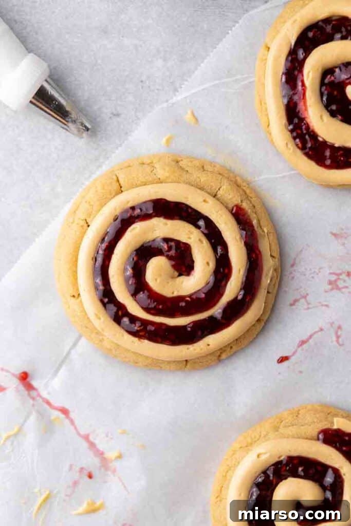 Soft Baked Peanut Butter and Jelly Cookies 14 Overhead shot of two beautifully frosted peanut butter and jelly cookies.