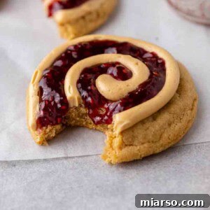 Soft Baked Peanut Butter and Jelly Cookies 15 Peanut butter and jelly cookies with a bite taken out of it