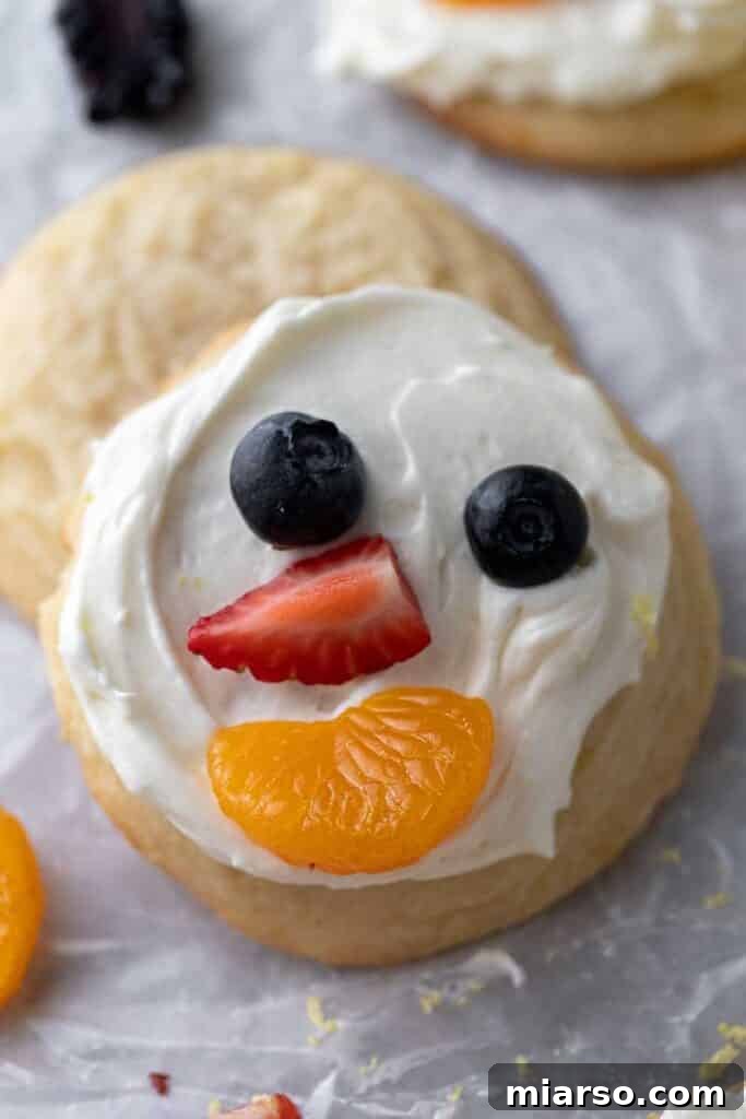 Close up of smiley face fruit pizza cookies decorated with various fruits