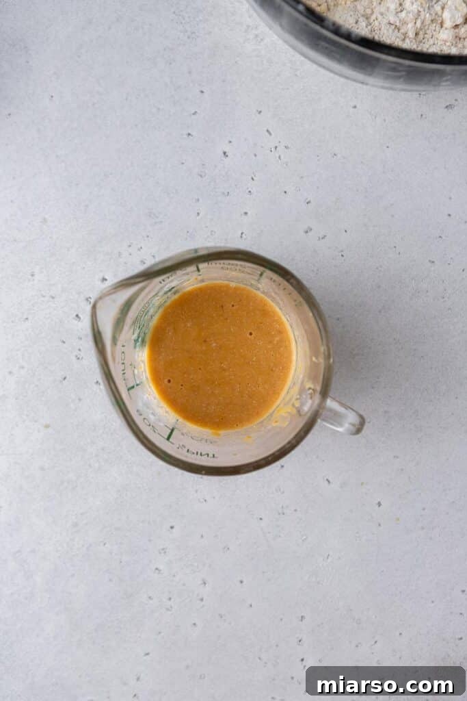 Mixing pumpkin puree and buttermilk into dry ingredients