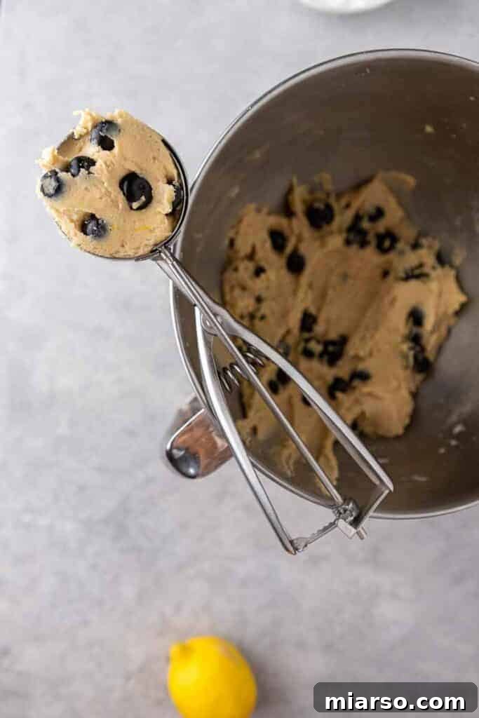 Bakery-Style Soft Blueberry Crumb Cake Cookies 8 Blueberry cookie dough in a cookie scooper