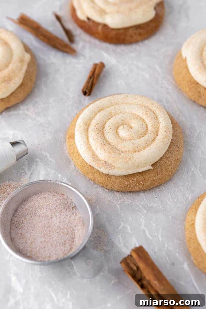 Close-up of three CRUMBL Snickerdoodle Cupcake Cookies, perfectly frosted and sprinkled.