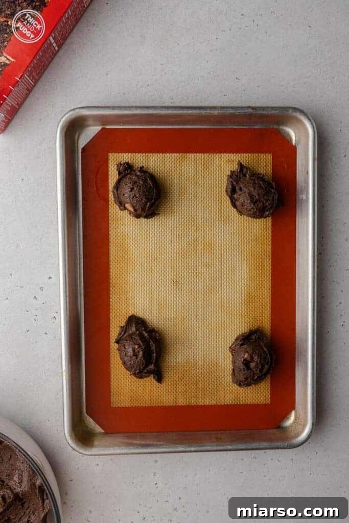 Crumbl's Rich Brownie Batter Indulgence 11 Uniform brownie batter cookies on a baking sheet before going into the oven