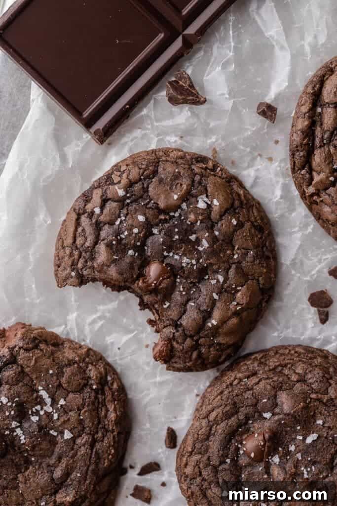 Crumbl's Rich Brownie Batter Indulgence 15 Overhead shot of freshly baked Crumbl brownie batter cookies, sprinkled with sea salt.