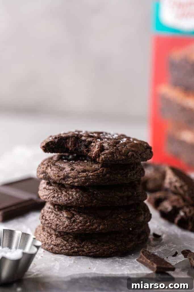 Crumbl's Rich Brownie Batter Indulgence 16 A stack of perfectly baked Crumbl brownie batter cookies, showing their thick, fudgy texture.