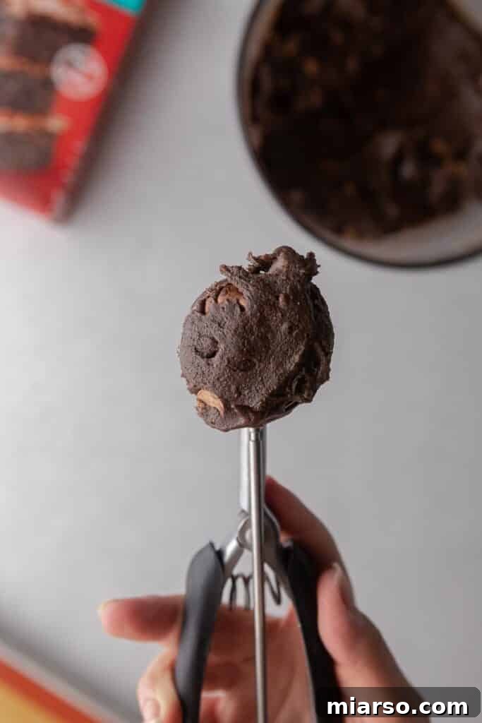 Crumbl's Rich Brownie Batter Indulgence 10 Using a cookie scooper to portion brownie batter cookie dough