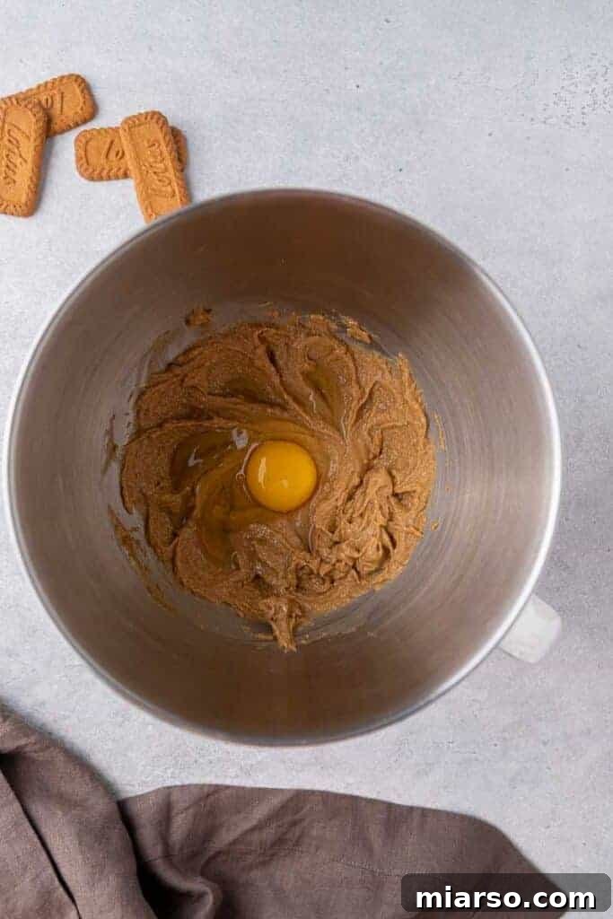 The Best Crumbl Biscoff White Chip Cookies Recipe 6 A mixing bowl showing creamed butter and egg, a crucial step in preparing the cookie dough.