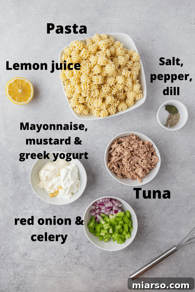 A vibrant array of fresh ingredients laid out for tuna pasta salad preparation