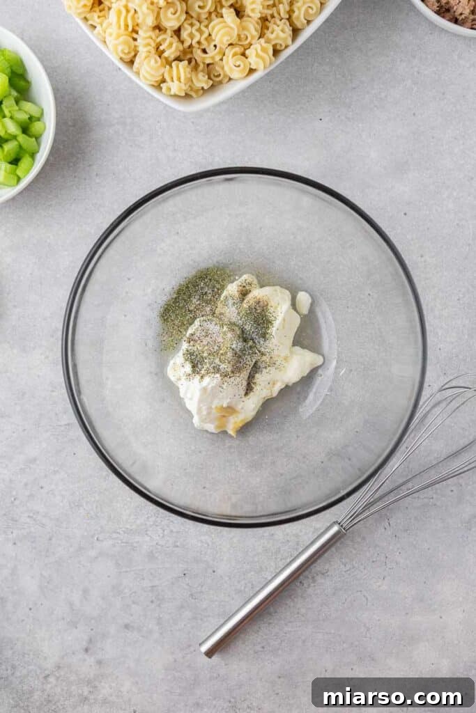Greek yogurt and mayo sauce being prepared in a bowl
