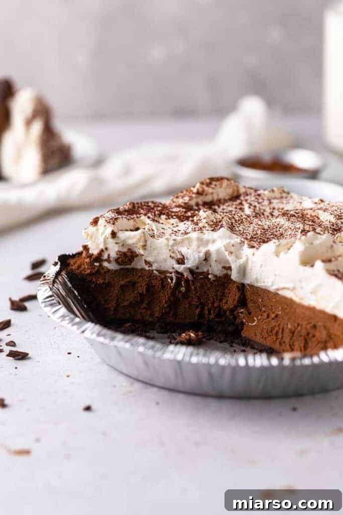 A tantalizing close-up of a sliced chocolate pie, revealing its creamy texture and crumbly crust.