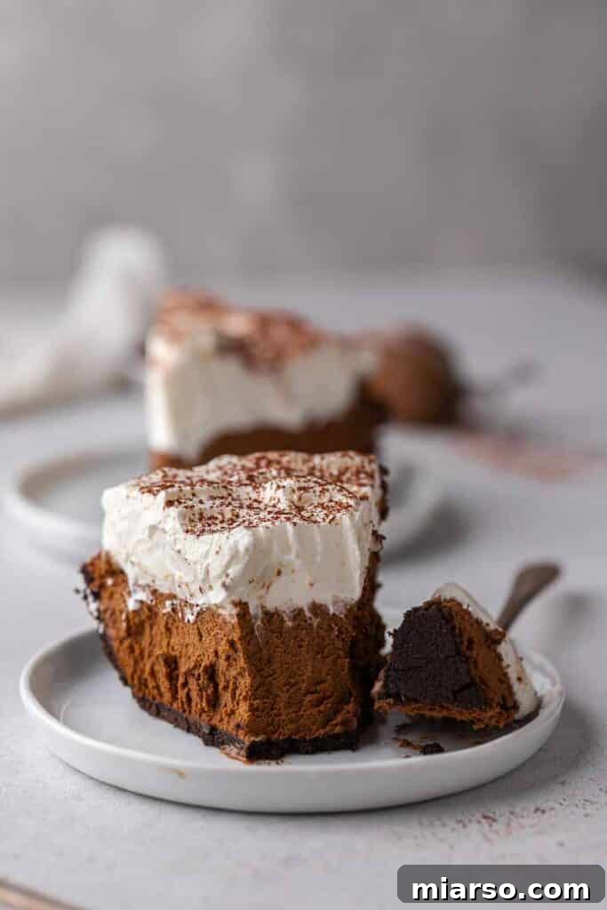 A perfectly sliced no-bake chocolate pie, ready to be enjoyed with a fork.