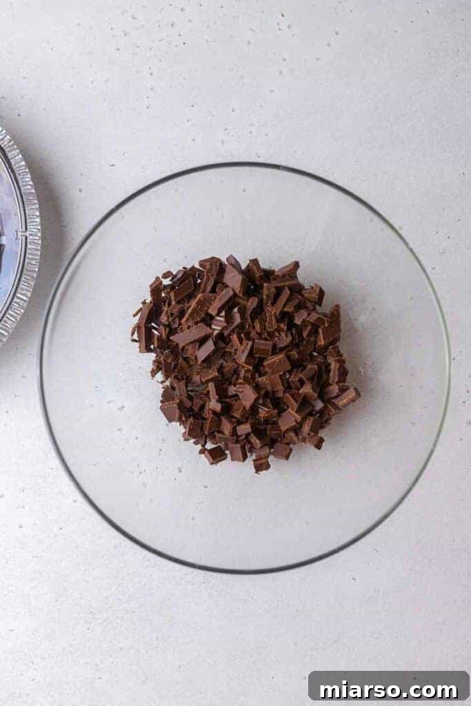 Finely chopped semi-sweet chocolate in a mixing bowl, ready for ganache.