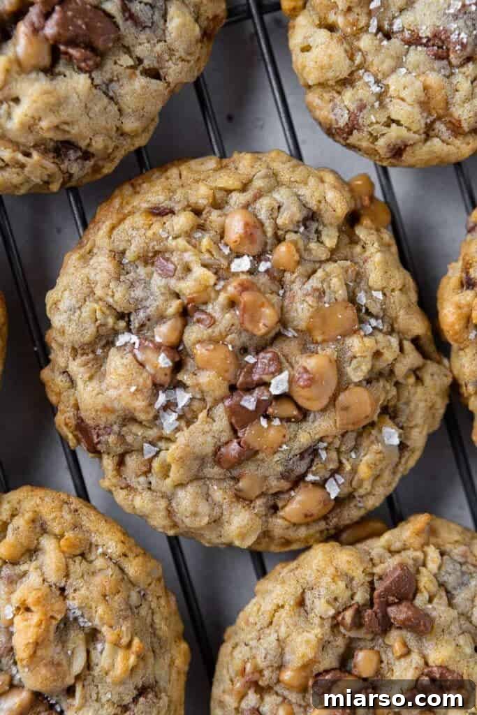 Freshly baked Crumbl Mom's Recipe Cookies on a parchment-lined baking sheet.