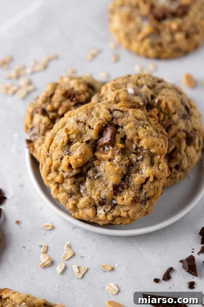 Close-up of a Crumbl Mom's Recipe Cookie, showcasing the gooey chocolate, melted toffee, and texture of the oats.