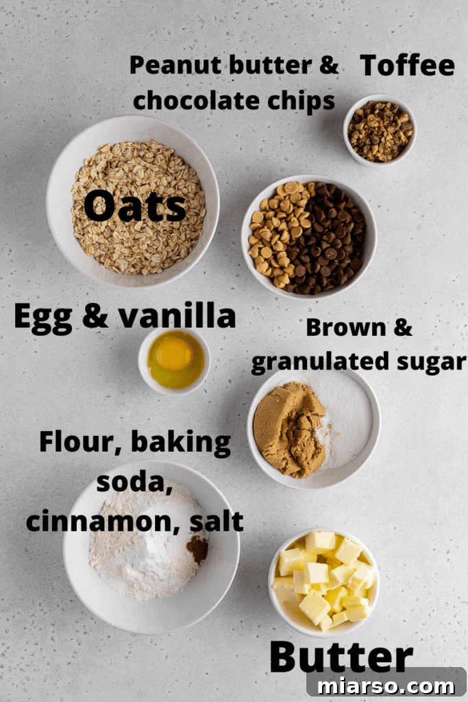 Ingredients laid out for Crumbl Mom's Recipe Cookies, including butter, sugars, eggs, flour, oats, chips, and toffee.