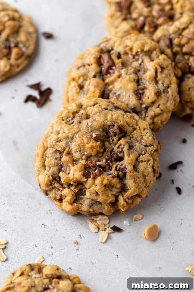 Detailed texture of the baked oatmeal toffee cookies, showing the melted chips and crispy edges.