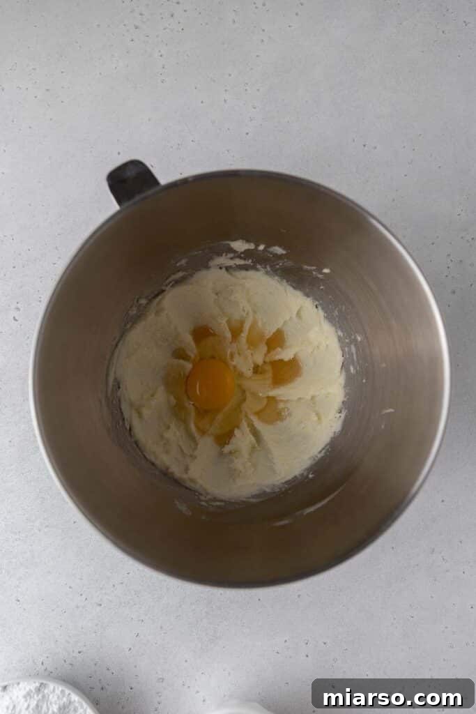 Creamed butter with eggs in a mixing bowl