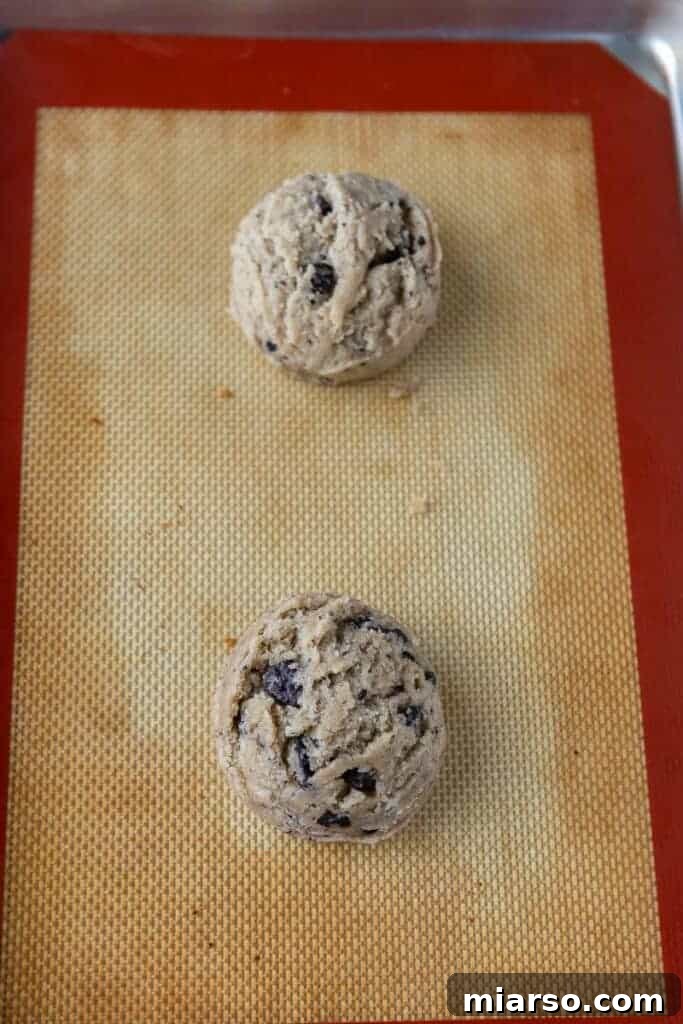 Scooped Oreo cookie dough balls on a baking sheet