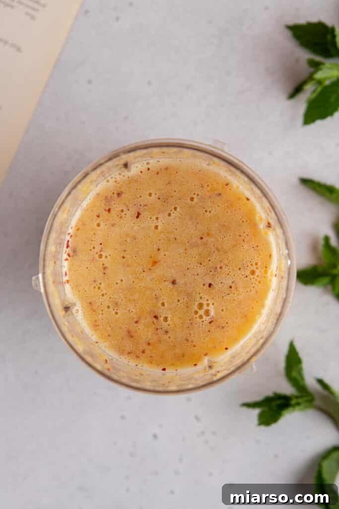 Blended peaches with water and sugar, creating a flavorful base for the peach syrup.