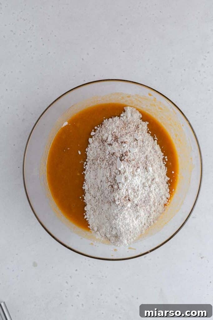 Wet ingredients with dry ingredients in a bowl