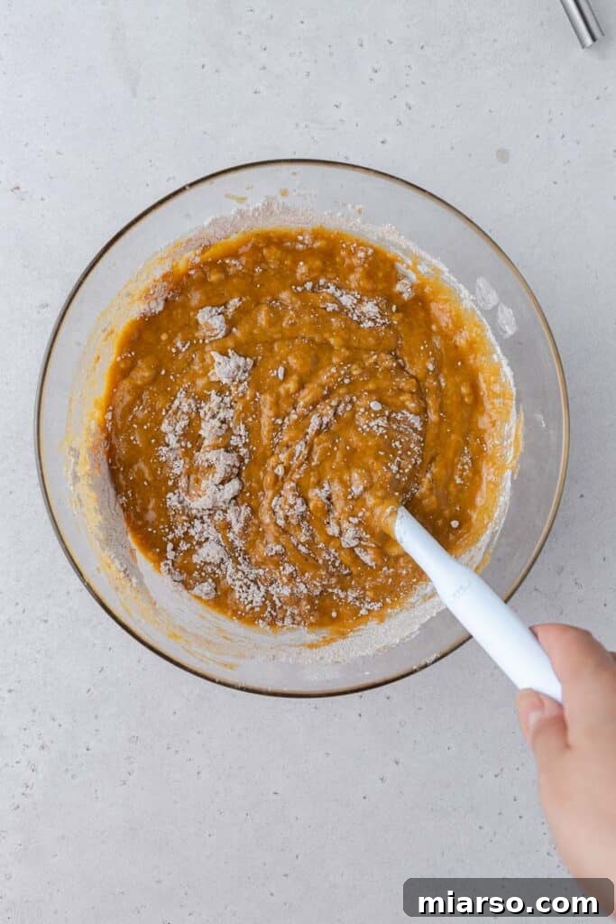 Wet ingredients with dry ingredients in a bowl