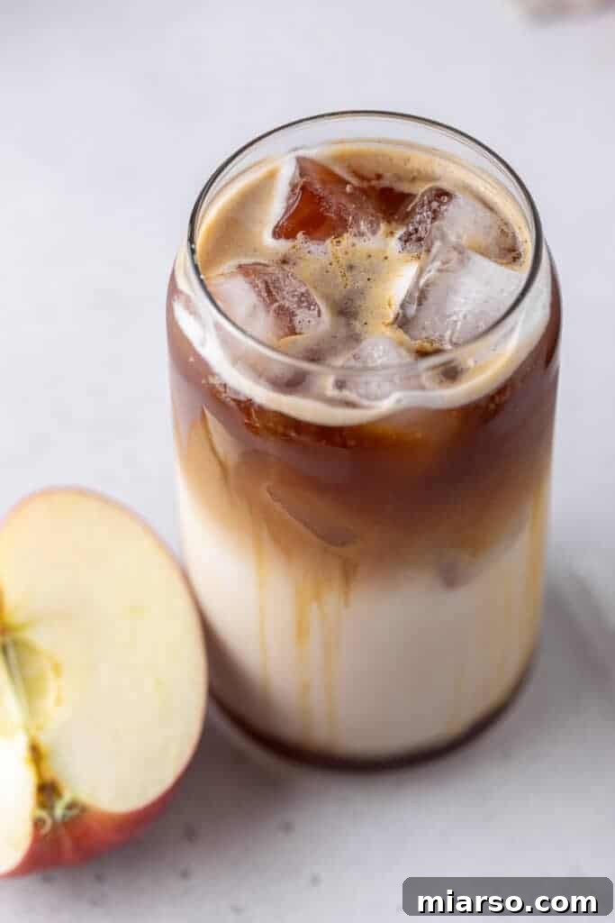 Starbucks Apple Crisp Macchiato 2 Iced Apple Crisp Macchiato with a straw in a glass