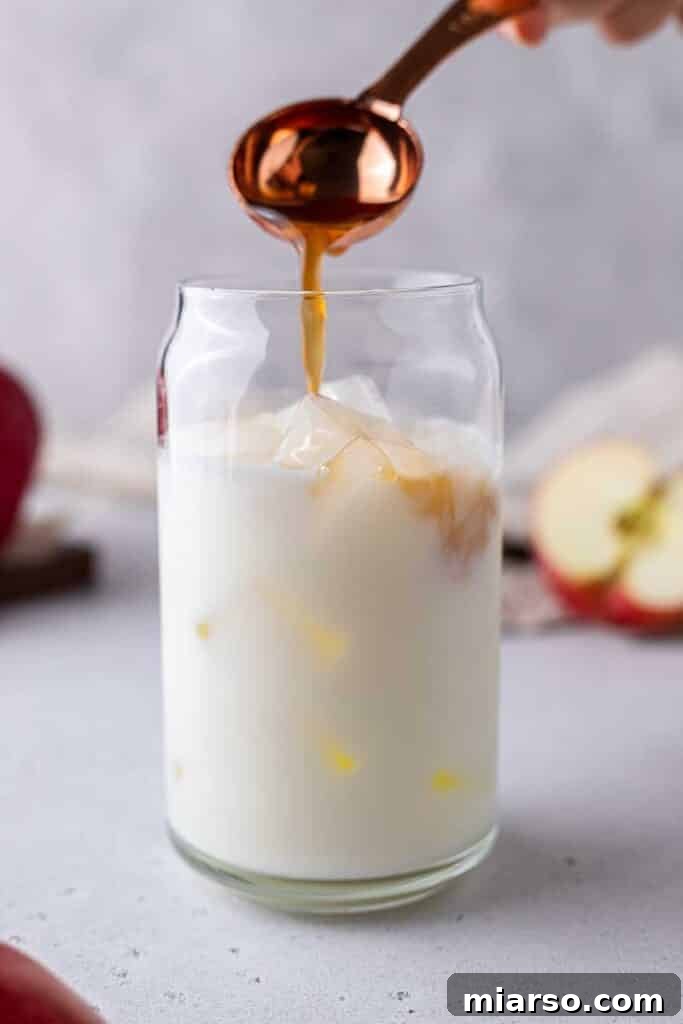 Starbucks Apple Crisp Macchiato 14 Adding apple simple syrup to milk in a glass