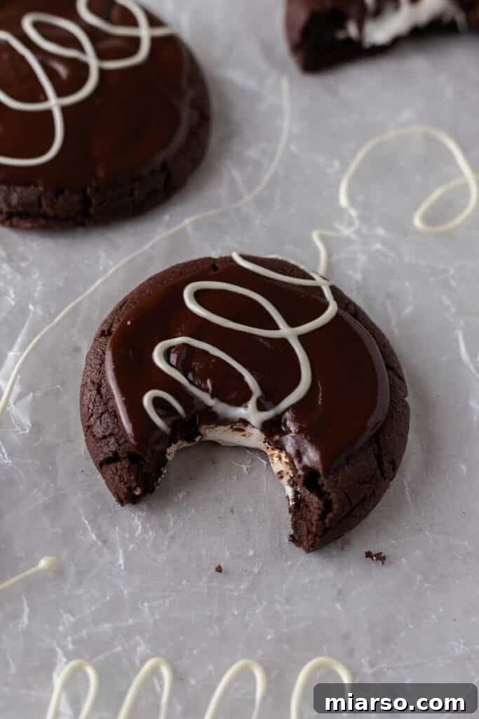 Crumbl chocolate mallow cupcake cookie with a bite taken out of it