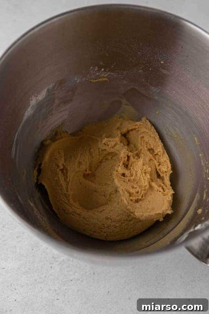 Pumpkin cookie dough in a mixing bowl, ready for scooping.