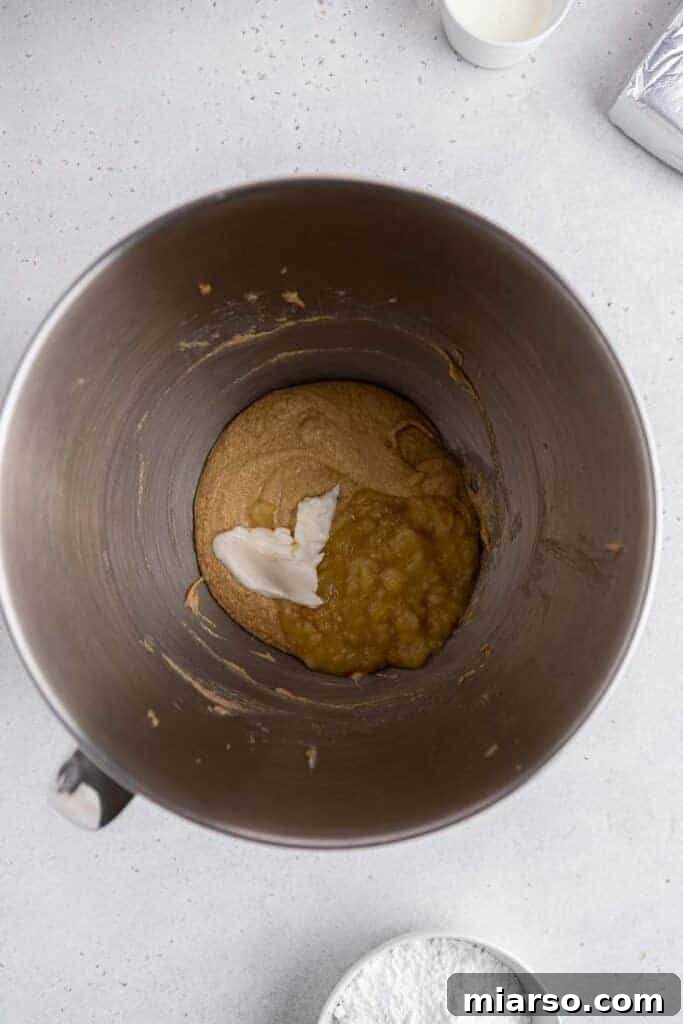 Sour cream with creamed butter in mixing bowl