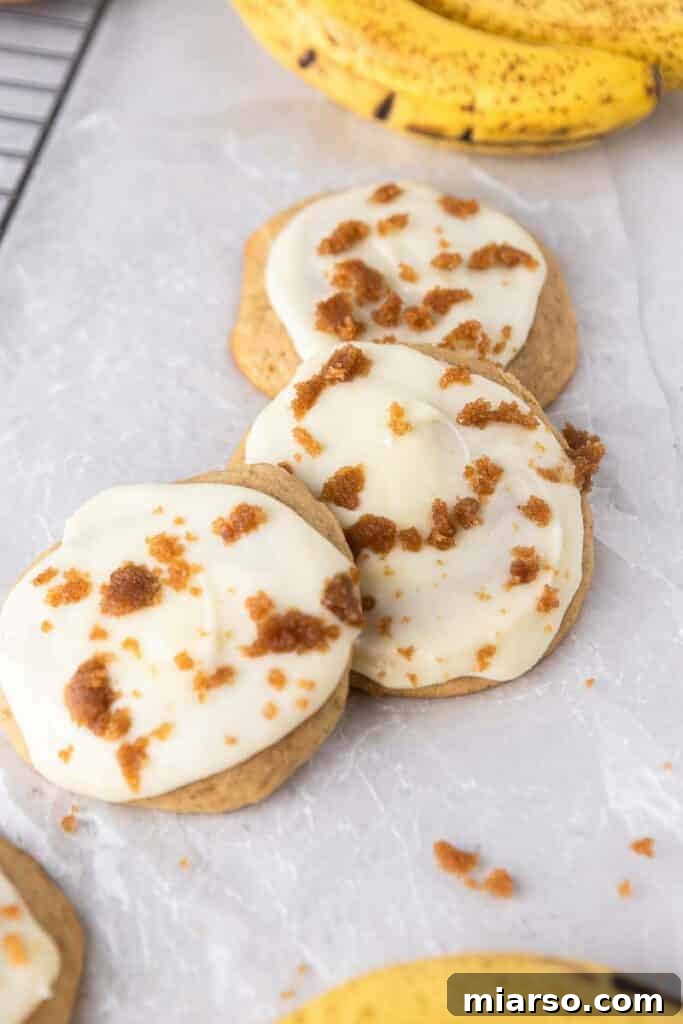 Glazed Crumbl banana bread cookies topped with brown sugar crumbs.