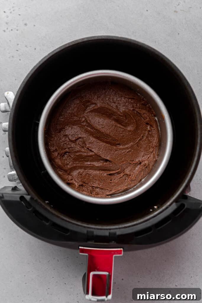 Brownie mix in a 6-inch pan inside an air fryer