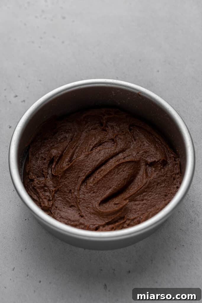 Brownie batter poured into a 6-inch pan