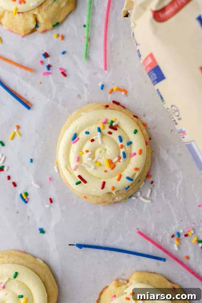 A stack of Crumbl Birthday Cake Cookies, showcasing their thick, frosted appearance