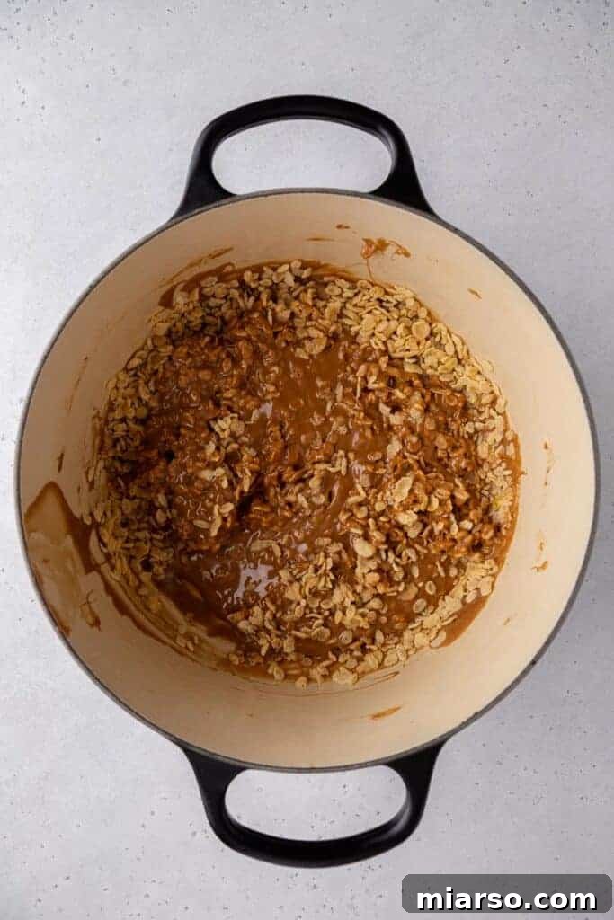 Rice Krispy cereal being mixed into melted chocolate.