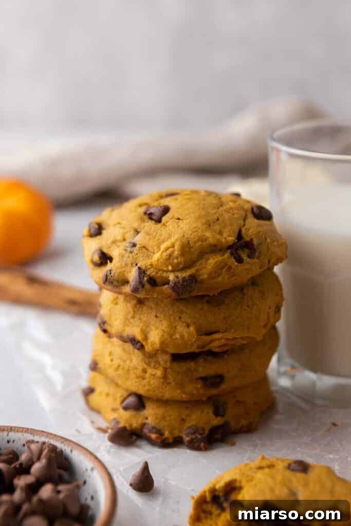 Gourmet Pumpkin Chocolate Chip Muffin Top Cookies 2 Stacked pumpkin chocolate chip cookies on a cooling rack