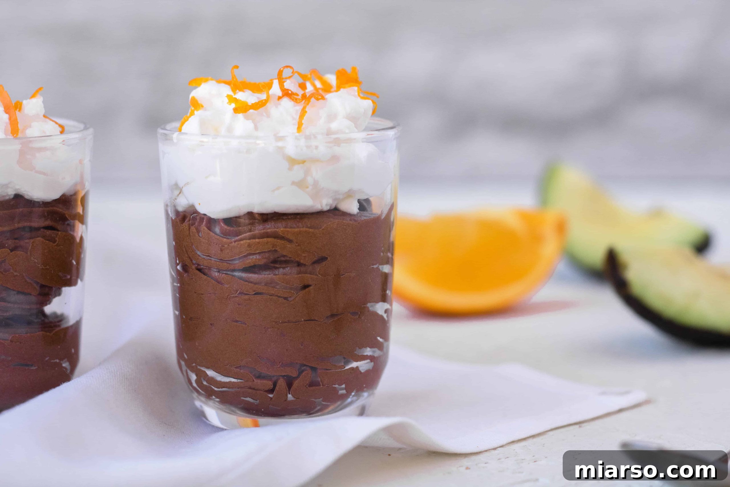 Healthy little glass jars of avocado chocolate orange mousse