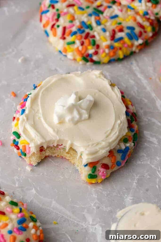 A delicious Crumbl funfetti milkshake cookie with a bite taken out of it, showcasing its soft interior and vibrant sprinkles.