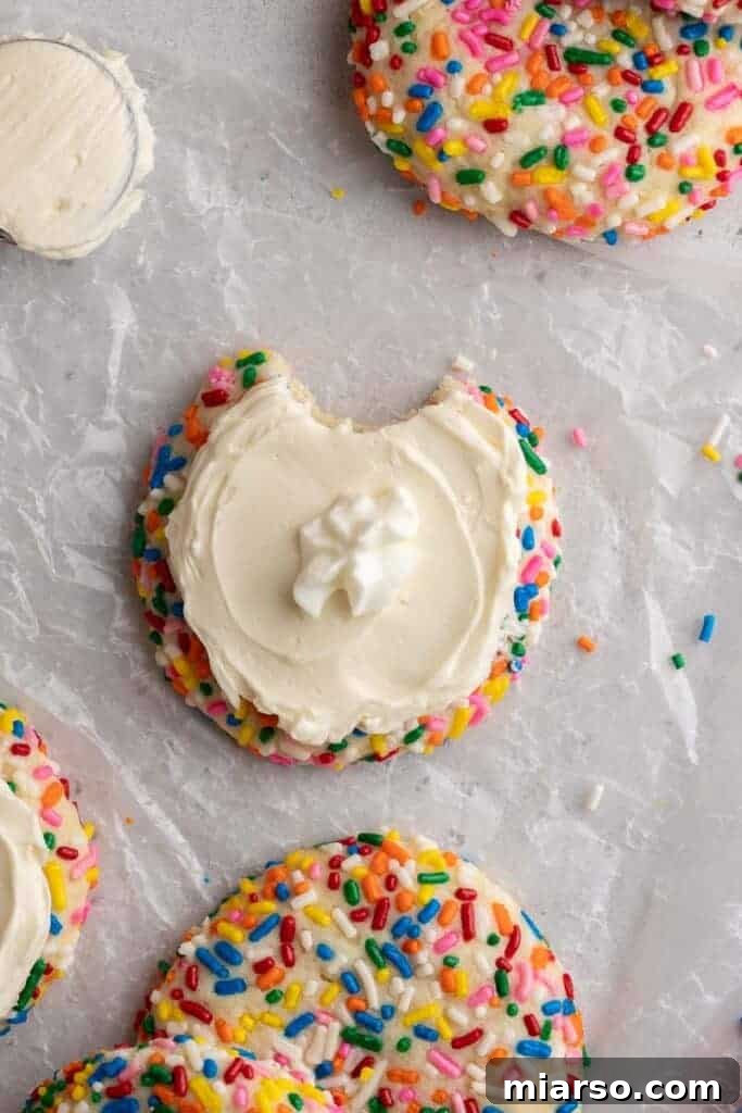 Overhead shot of perfectly frosted funfetti cookies with sprinkles.