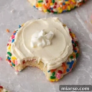 Crumbl funfetti milkshake cookie with a bite taken out of it