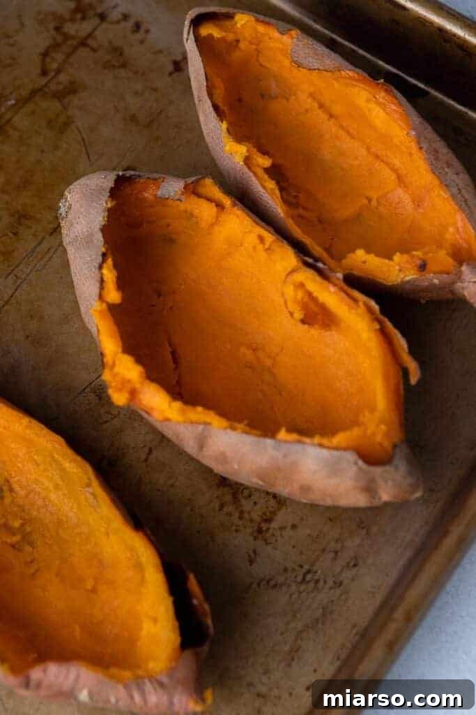 Pecan Pie Twice-Baked Sweet Potato Delight 5 Sweet potatoes hollowed out after roasting showing smooth orange interior ready for filling