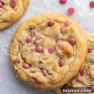 Overhead shot of thick ruby chocolate chip cookies with a sprinkle of extra chips
