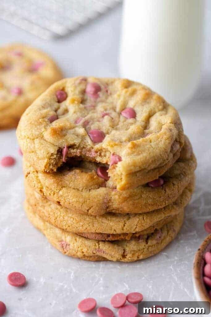 Stack of freshly baked Crumbl ruby chocolate chip cookies showcasing their thick, soft texture