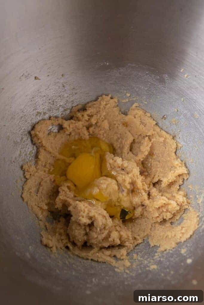 Close-up of butter and sugars being creamed in a stand mixer, creating a light and fluffy texture