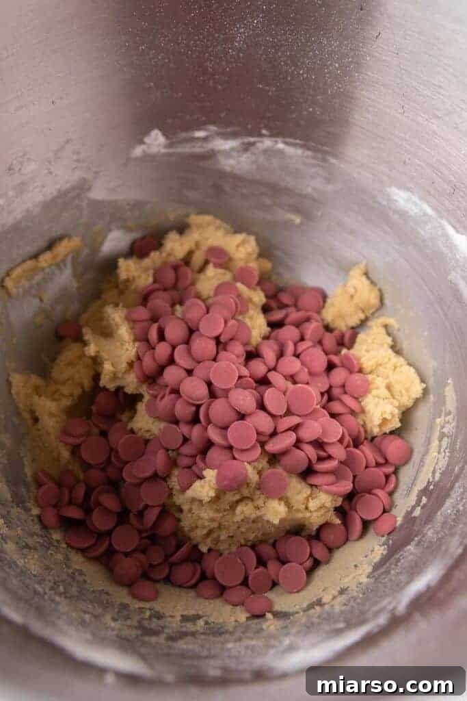 Cookie dough with ruby chocolate chips ready for scooping