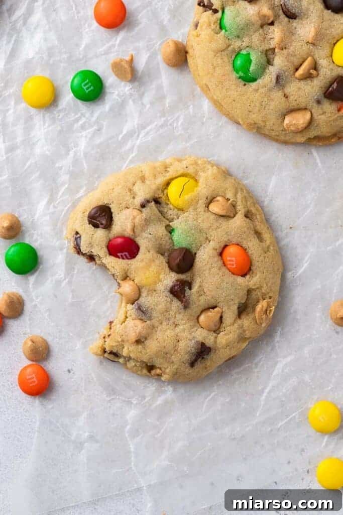 Overhead shot of Crumbl monster cookies - thick, chewy, and loaded with M&M's, peanut butter, and chocolate chips.
