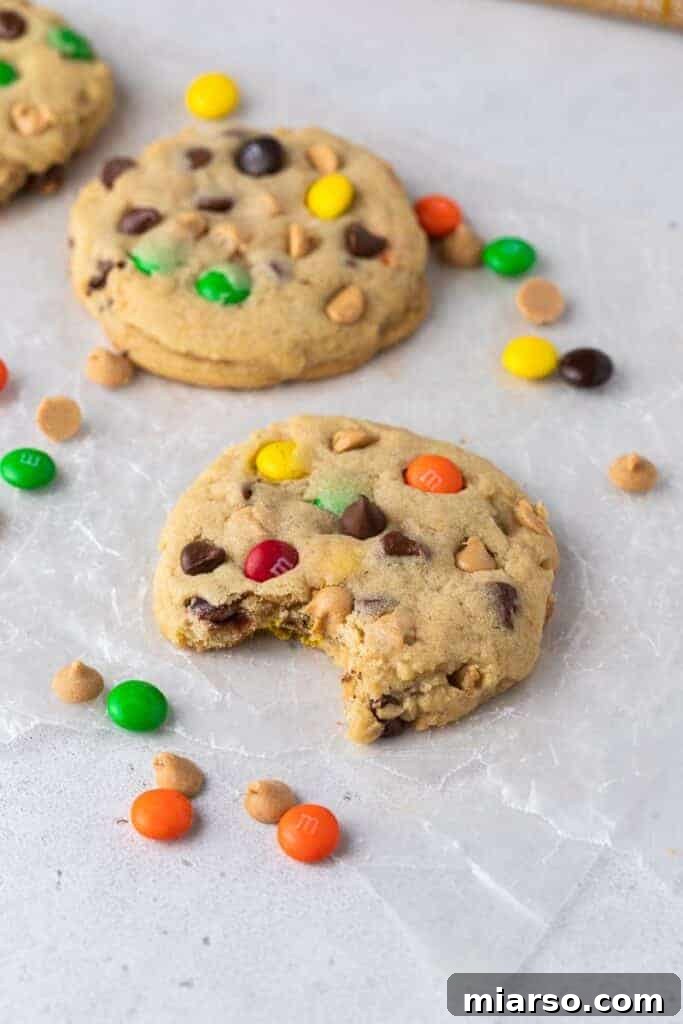 Giant Crumbl monster cookie with a bite taken out of it, showcasing the thick texture and inclusions.