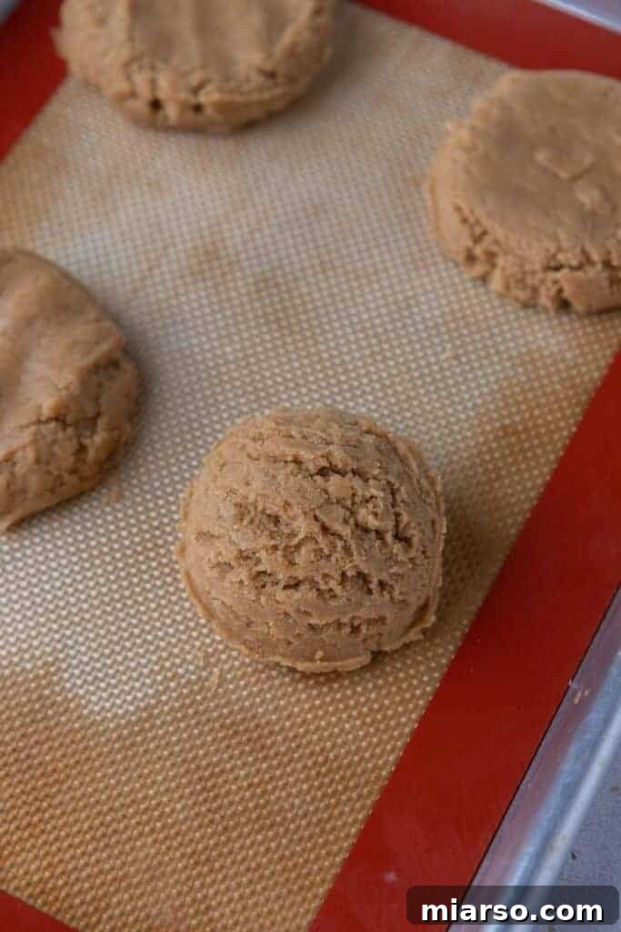 Shaping peanut butter cookie dough balls.