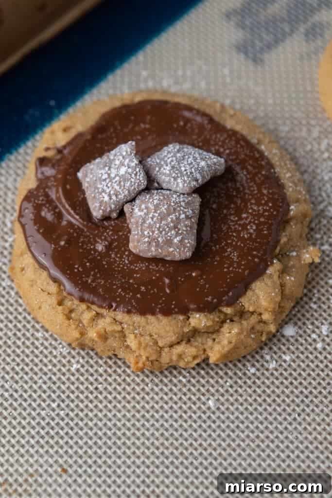 Crumbl Muddy Buddies cookies with chocolate and cereal topping.