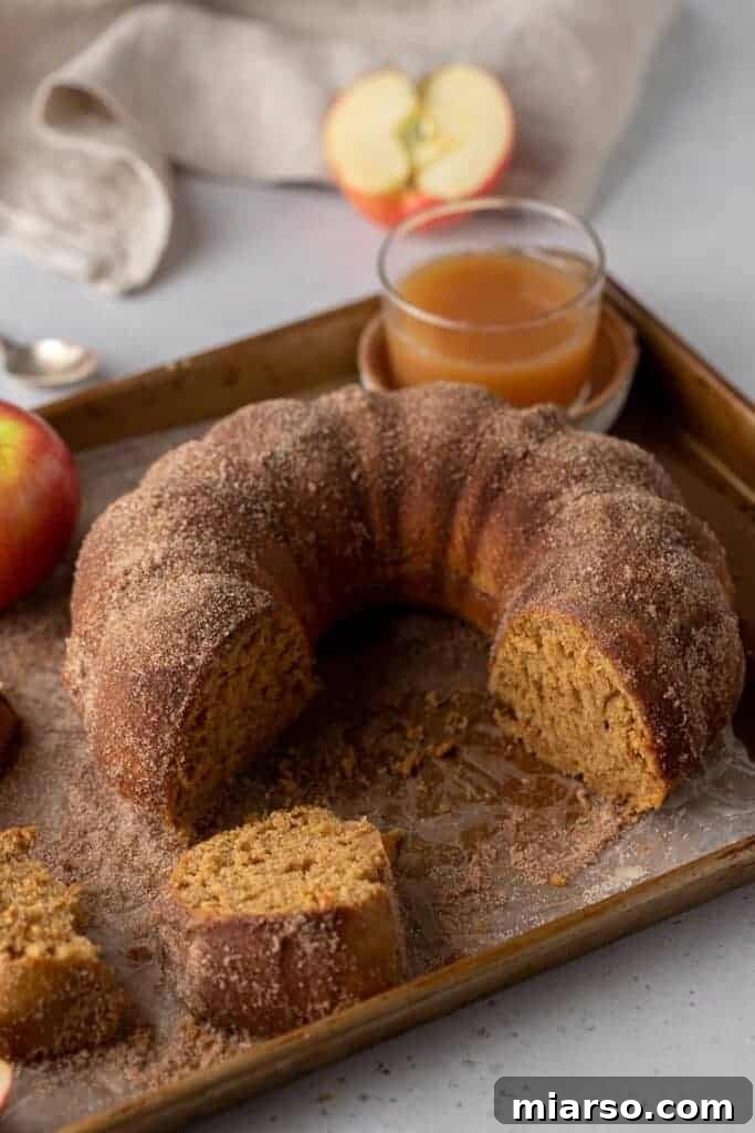 Apple cider bundt cake on baking sheet, a perfect fall dessert.